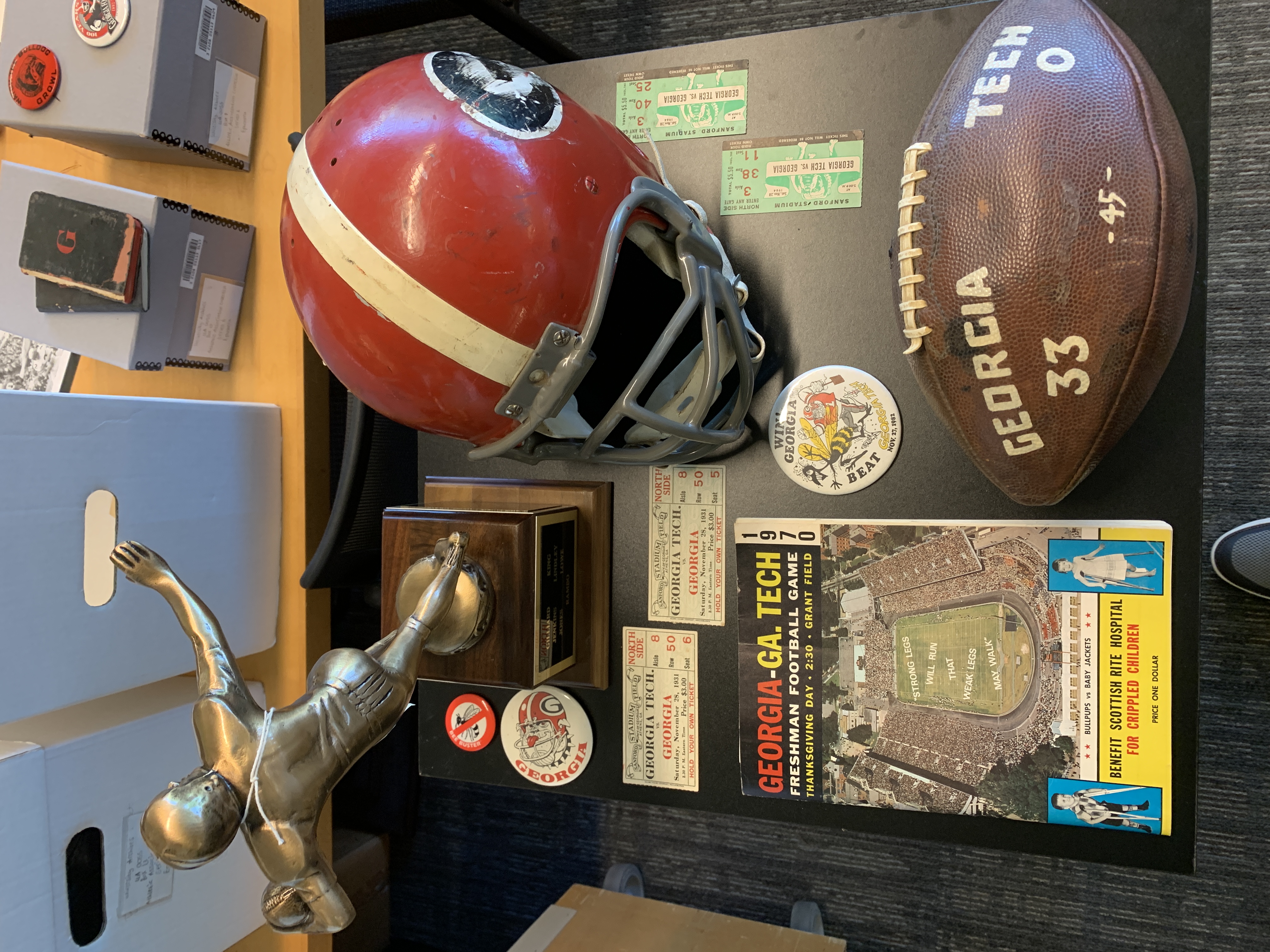 display with red UGA helmet, tickets, a trophy, and other memorabilia