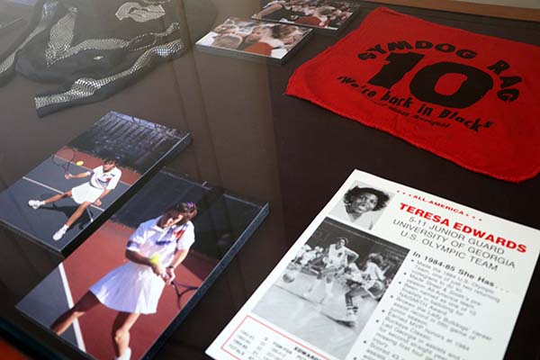 Display of photos, a magazine cover and clothing related to UGA Olympian Teresa Edwards.