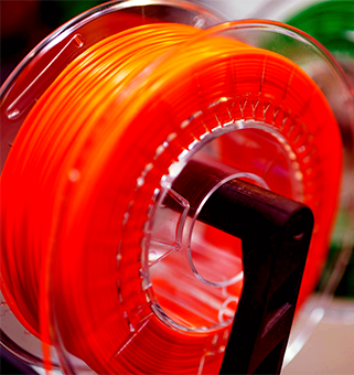 spool of red 3D printer filament
