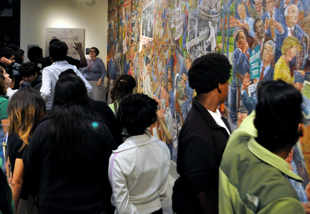 Jill Severn discusses the mural with 8th grade students.