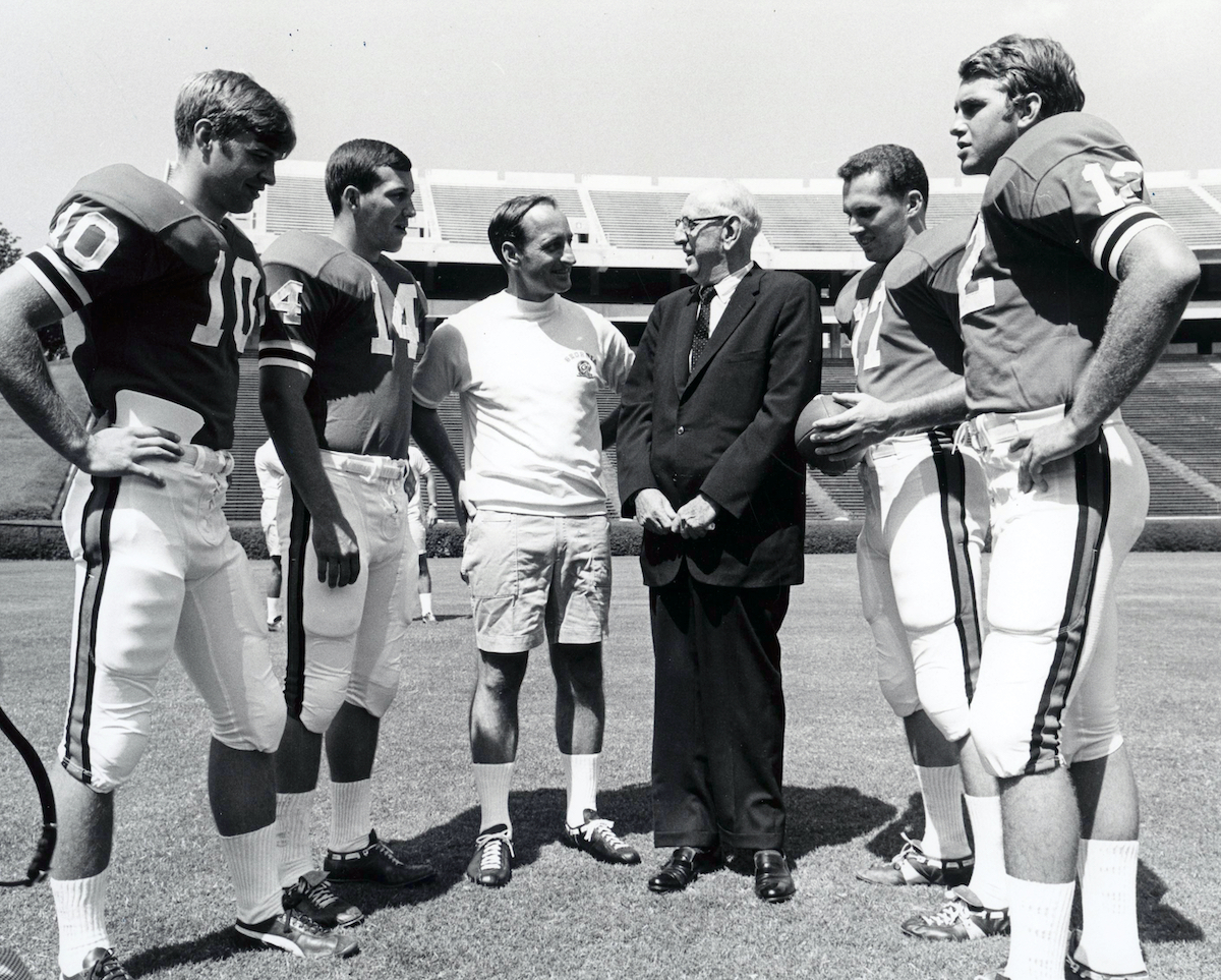 Russell visiting with Coach Vince Dooley and members of the University of Georgia football team at Sanford Stadium in 1969. 
