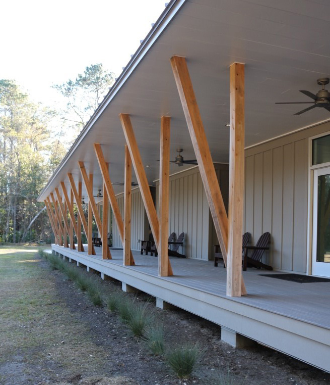 Modern building with a porch with raw wood  supports